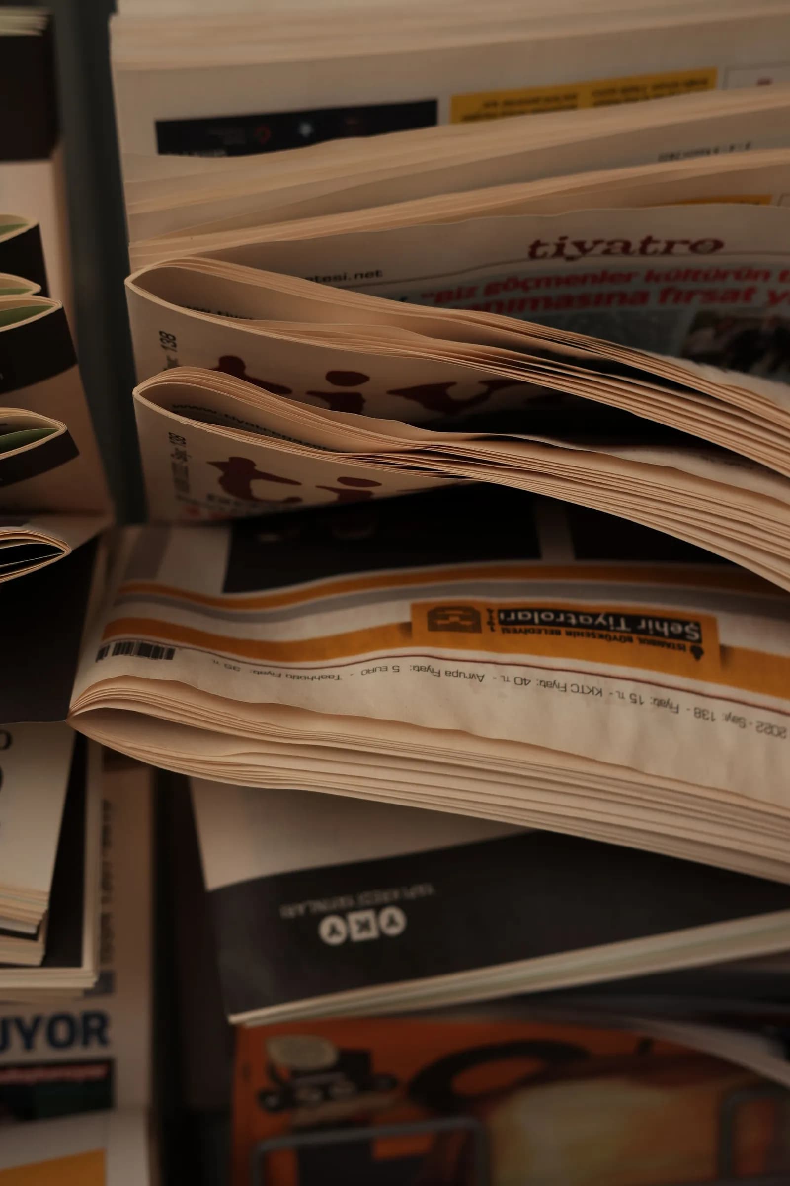 Detail of newsprint headlines stacked in a rack